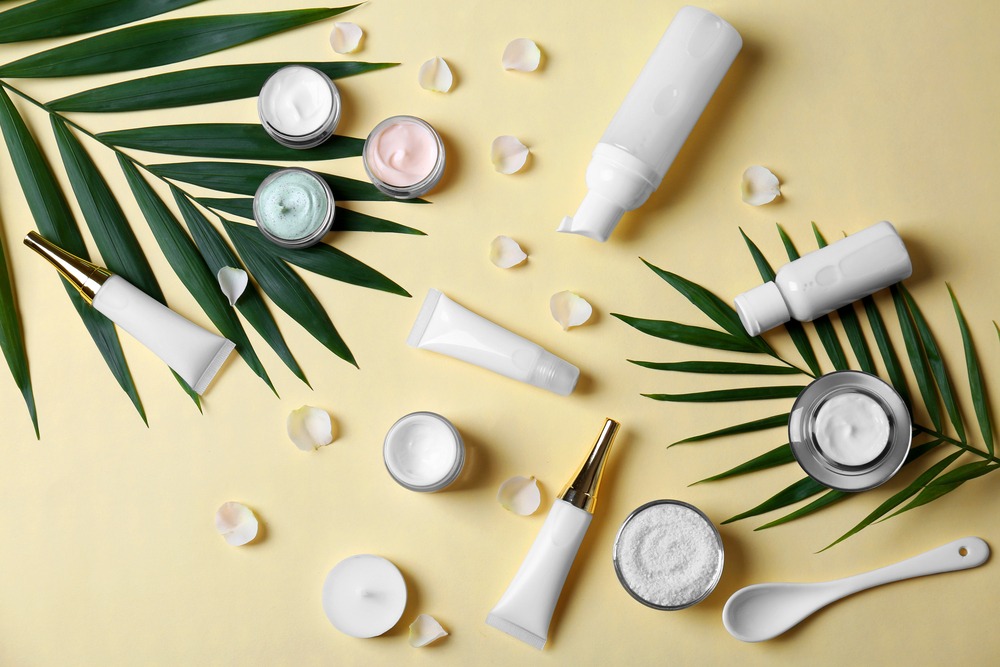 a variety of skincare products, yellow background